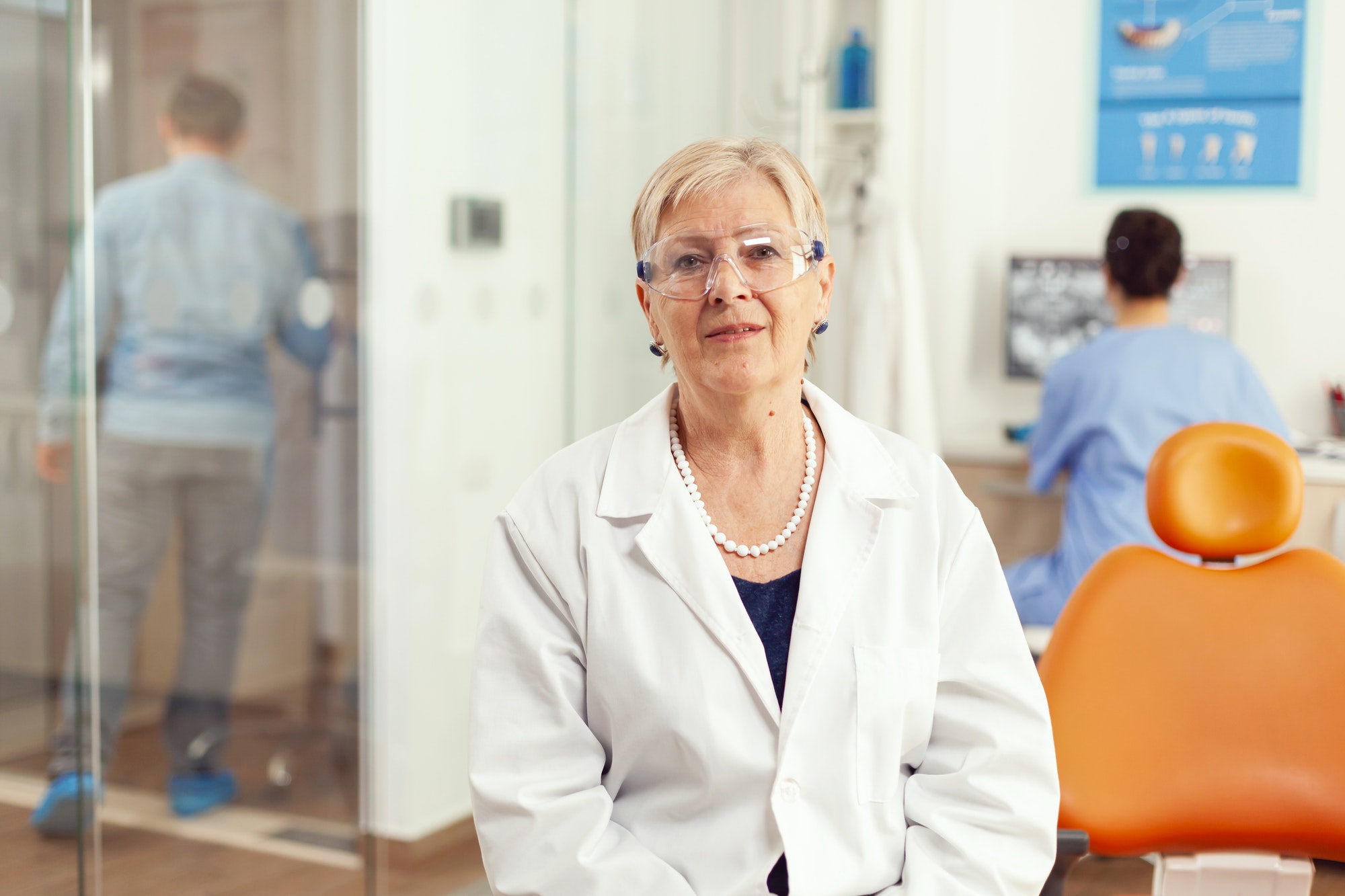Portrait of specialist senior dentist woman in stomatological office