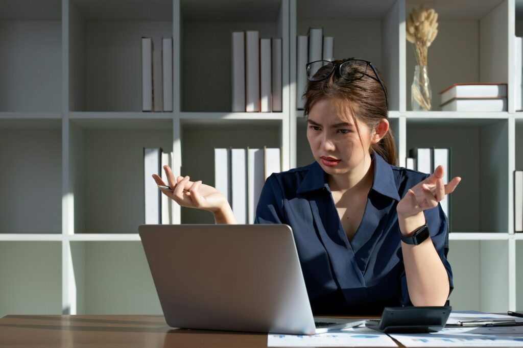 The accountant is stressed while calculating the mismatched taxes and finances.