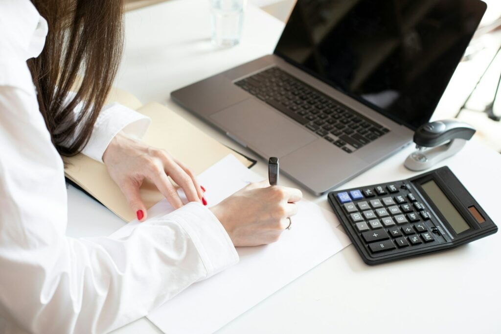 Accountant at work writing signing documents