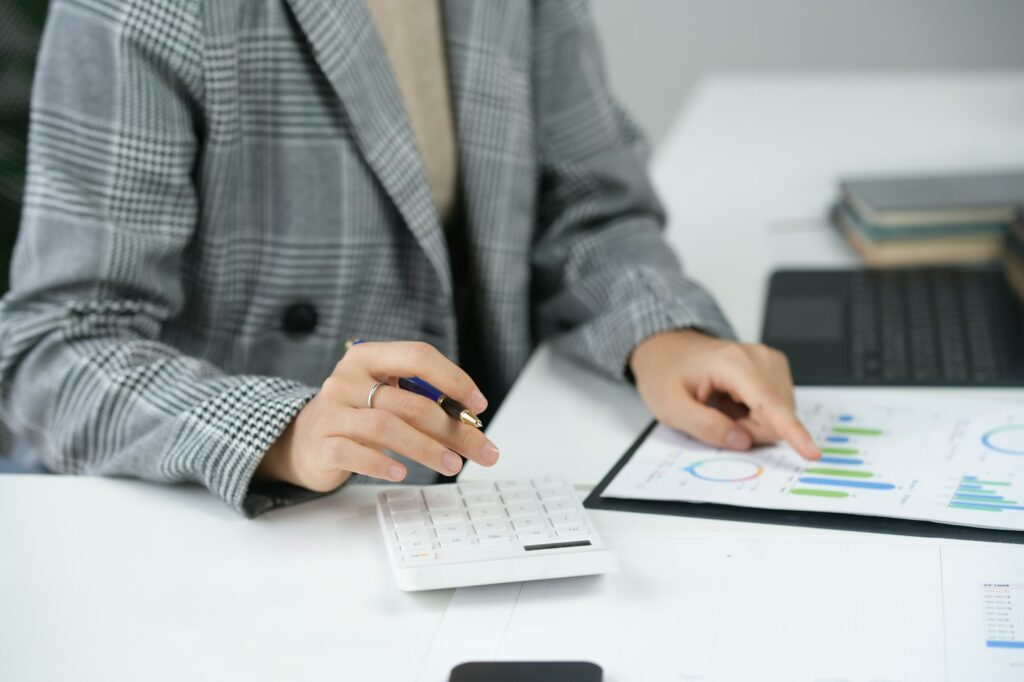 Business professional analyzing financial data charts at desk