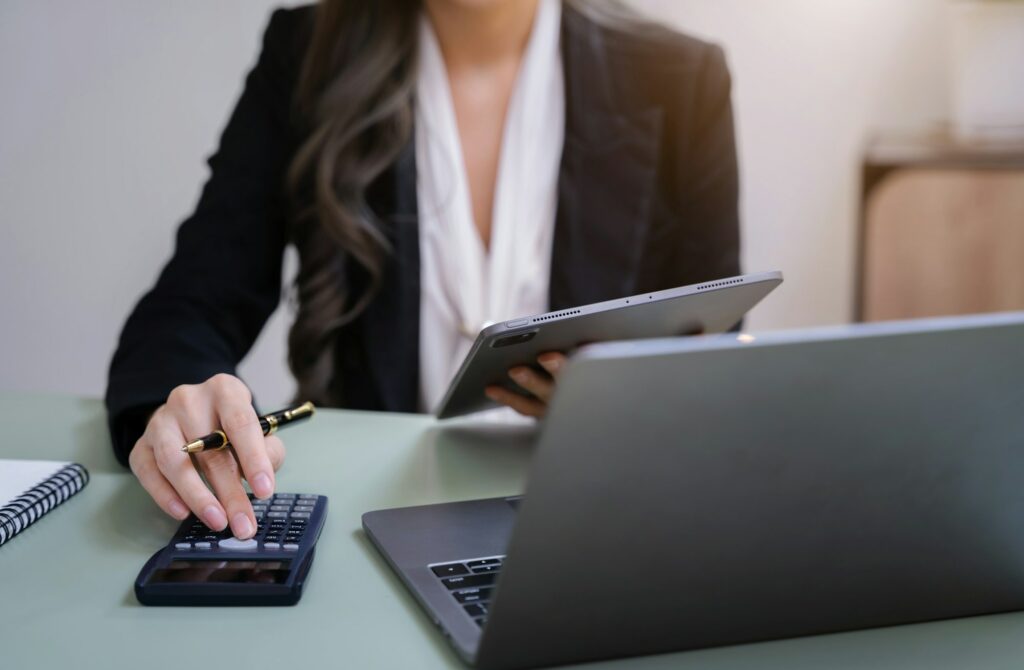 accountant working on laptop and calculator on office.